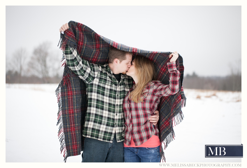 Drakes Island Engagement Session | Maine Beach Engagement Session | New England Wedding Photographer | Winter Beach Engagement | Melissa Beck Photography_0034 couple kissing under a blanket Kennebunk maine