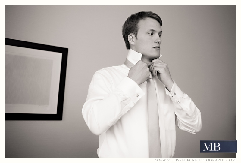 groom putting on his tie