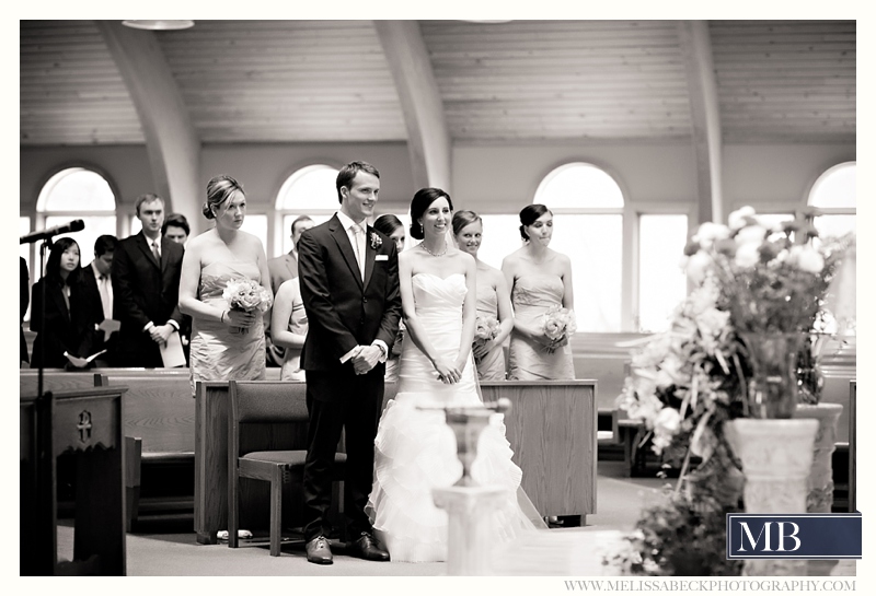 bride and groom standing at a church ceremony