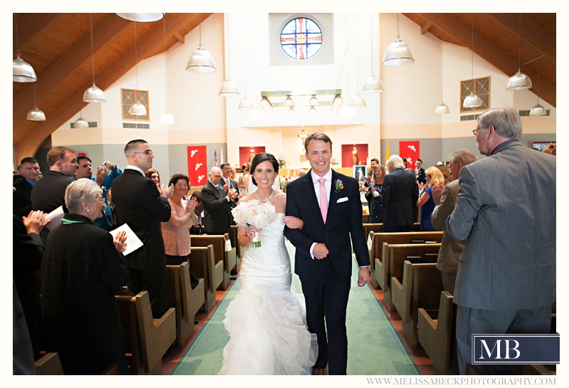 bride and groom walk down the isle