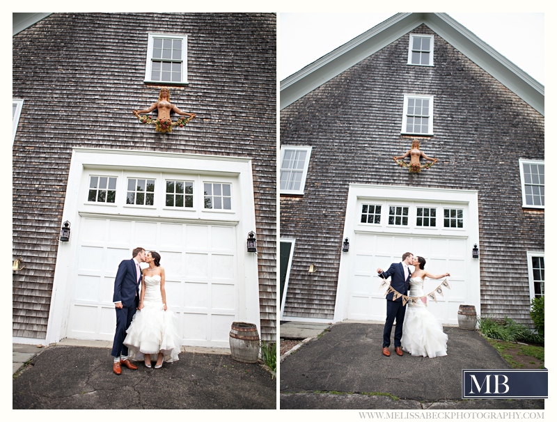 bride and groom kissing in front of gray barn at mt hope farms