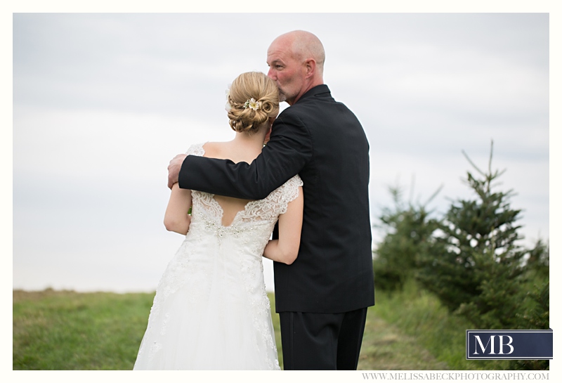 father kisses bride